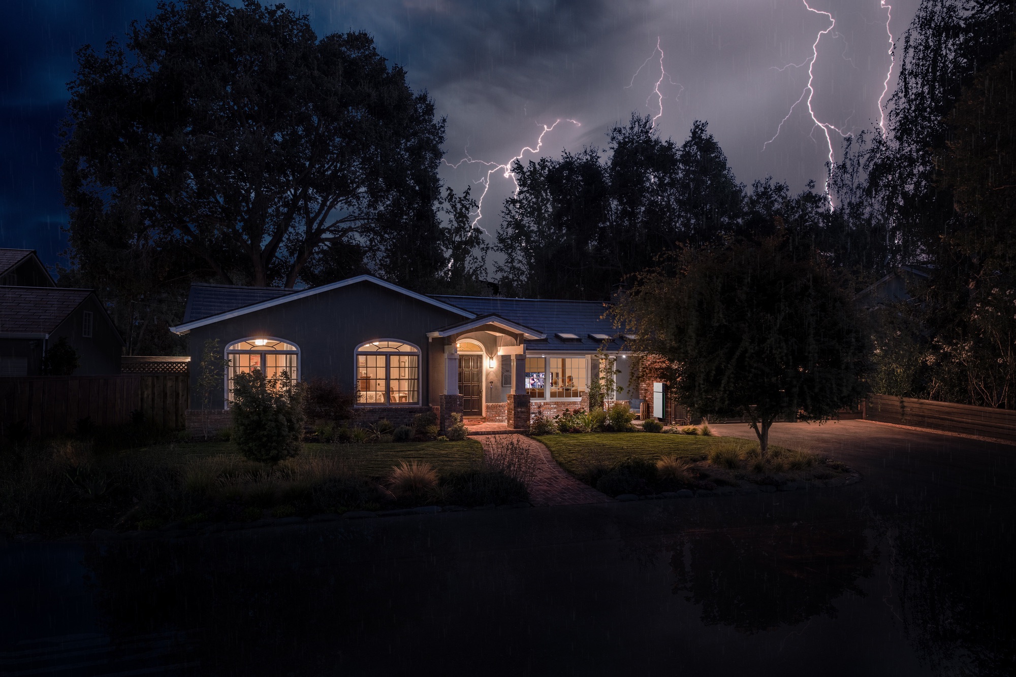 Home with lights on during a lightning storm — solar battery backup keeps power on